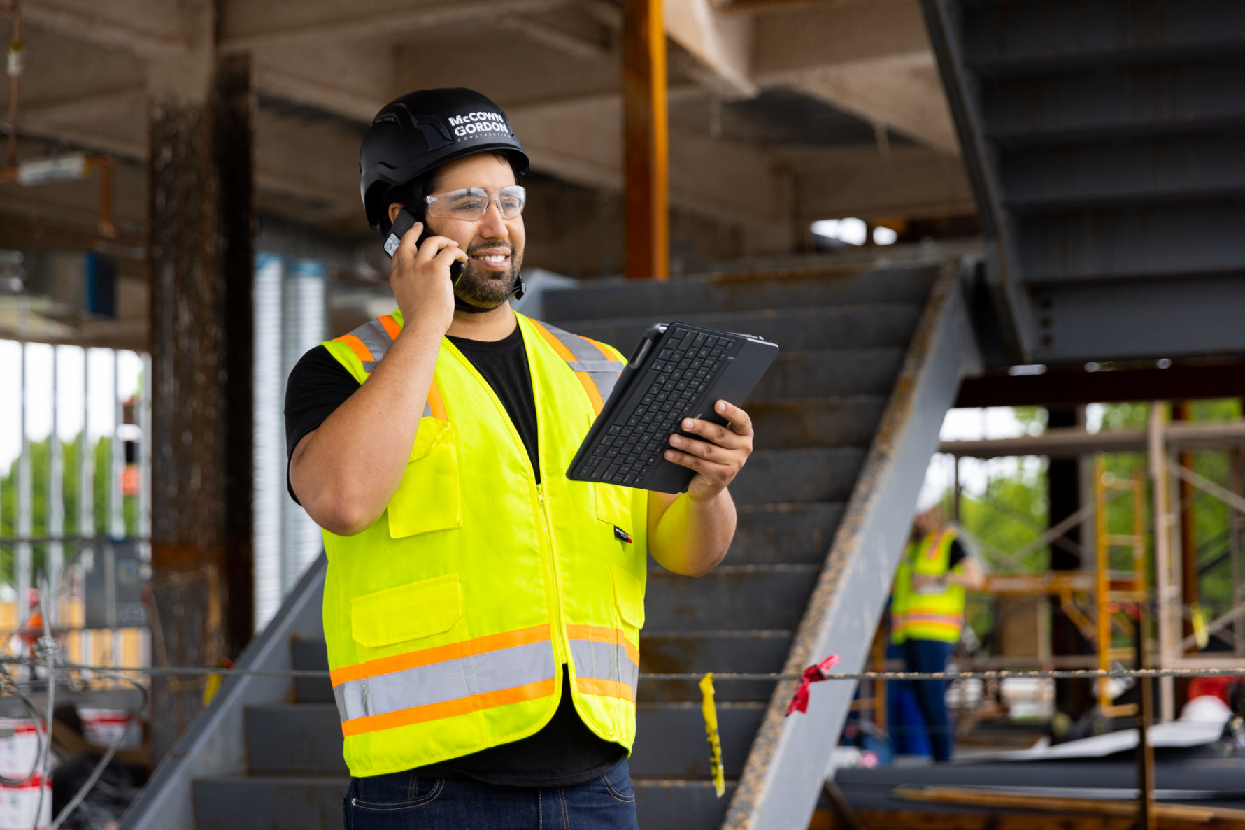 A McCownGordon associate talking on the phone while on a construction site