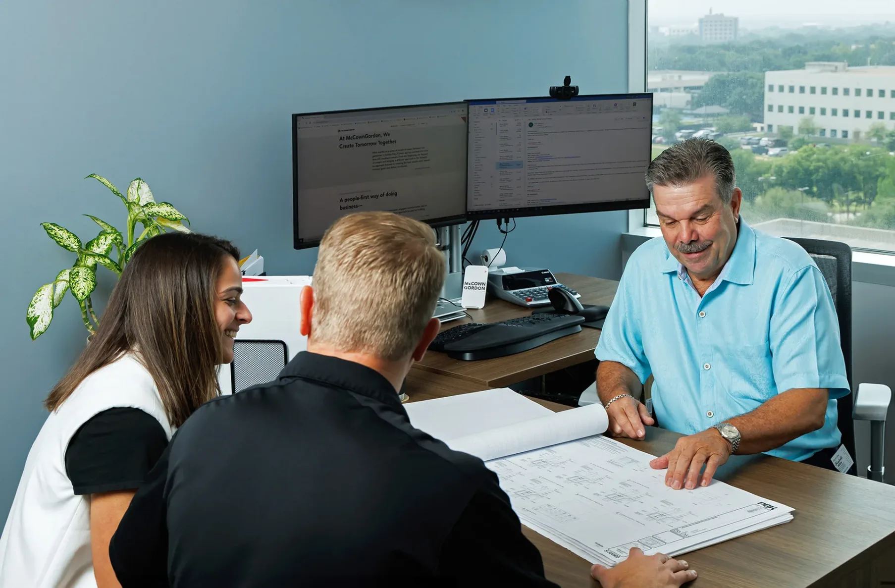 McCownGordon associates meeting in an office and talking