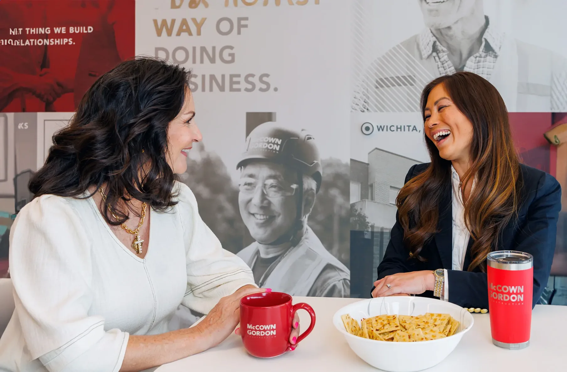 Two McCownGordon associates laughing and having a snack at the office