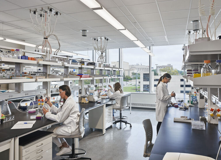 Researchers and scientists working in a lab at KU, built by McCownGordon Construction