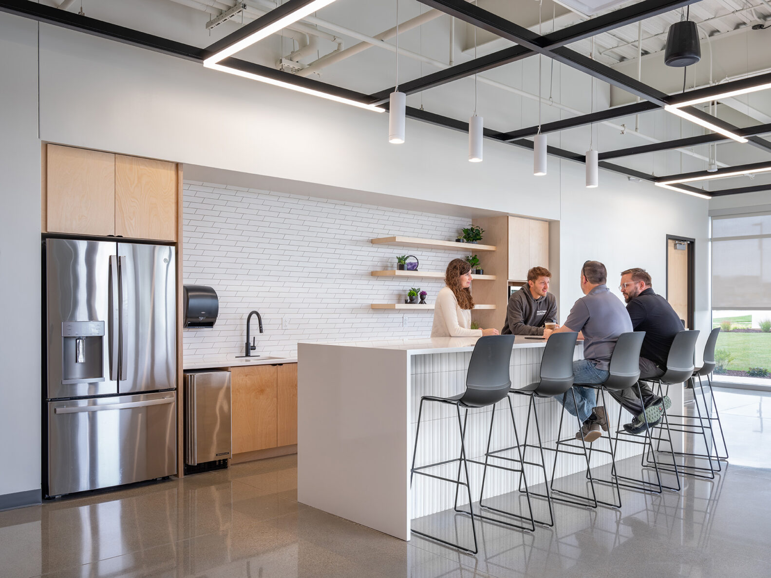 People chatting in the kitchen at the KSU Office Park, built by McCownGordon Construction